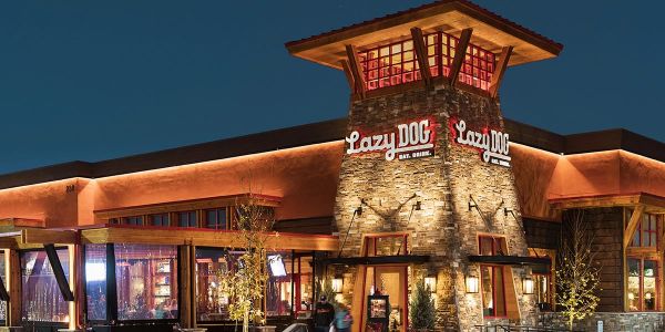 Valley Creek Restaurant building at night with warm lighting and a western-style design.