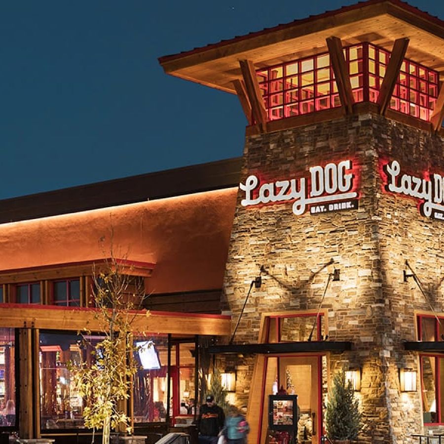 Valley Creek Restaurant building at night with warm lighting and a western-style design.