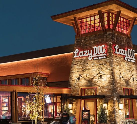 Valley Creek Restaurant building at night with warm lighting and a western-style design.